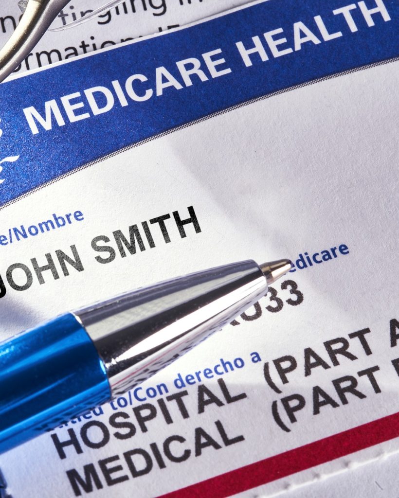 THE SEA RANCH, CALIFORNIA - November 8, 2018: Medicare Health Insurance card on medical report with glasses. Medicare is a national health insurance program provided by the United States for seniors 65 and older. It began in 1966.